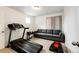Home workout room featuring treadmill, sofa and exercise equipment at 947 W Beverly St, Elizabeth, CO 80107