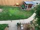 Backyard with a green lawn, chicken coop, bench, and a winding concrete path at 4332 Bruce Randolph Ave, Denver, CO 80207