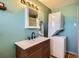 Bathroom with a modern sink, vanity, mirror, and in-unit washer and dryer combo at 4332 Bruce Randolph Ave, Denver, CO 80207