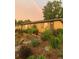 Charming home with a lush, landscaped front yard and a rainbow in the sky at 4332 Bruce Randolph Ave, Denver, CO 80207