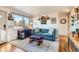 Inviting living room with a comfortable blue sofa and bright natural light at 4332 Bruce Randolph Ave, Denver, CO 80207