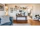 Bright living room with gallery wall and view into the kitchen at 4332 Bruce Randolph Ave, Denver, CO 80207