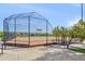 Well-maintained baseball field with covered dugout, netting, and accessible paved walkway at 479 Interlocken Blvd # 105, Broomfield, CO 80021