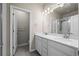 Bright bathroom with double vanity, quartz countertops, and a glass-enclosed shower at 479 Interlocken Blvd # 105, Broomfield, CO 80021