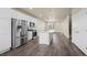 Modern kitchen with stainless steel appliances, white cabinets, an island with bar seating, and hardwood flooring at 479 Interlocken Blvd # 105, Broomfield, CO 80021