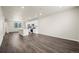 Open-concept living room and kitchen featuring hardwood floors, recessed lighting, and neutral wall paint throughout at 479 Interlocken Blvd # 105, Broomfield, CO 80021