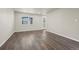 Spacious living room with hardwood flooring, natural light, and a white door leading to the exterior at 479 Interlocken Blvd # 105, Broomfield, CO 80021
