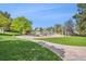 Scenic park with a playground featuring various climbing structures and a winding walking path at 479 Interlocken Blvd # 105, Broomfield, CO 80021