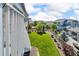 Well-maintained backyard features lush green grass, mature trees, and a wooden fence at 23913 E Swallow Cir, Aurora, CO 80016