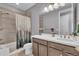 Modern bathroom with a shower/tub combo, wood-style tile, and updated vanity at 23913 E Swallow Cir, Aurora, CO 80016