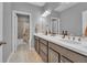 Bathroom featuring double sink vanity, framed mirrors, vanity lighting and tile flooring at 23913 E Swallow Cir, Aurora, CO 80016