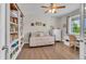Cozy bedroom featuring built-in bookshelves, hardwood floors, and natural light at 23913 E Swallow Cir, Aurora, CO 80016