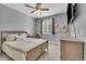 Cozy bedroom with ceiling fan, plush carpet, large window, and calming grey walls at 23913 E Swallow Cir, Aurora, CO 80016