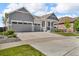 Charming two-story home with a three-car garage and well-maintained landscaping at 23913 E Swallow Cir, Aurora, CO 80016