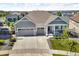Gray two-story home featuring a three car garage and covered porch at 23913 E Swallow Cir, Aurora, CO 80016