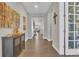 Inviting hallway with hardwood floors, neutral walls, and decorative accents leading to the living area at 23913 E Swallow Cir, Aurora, CO 80016