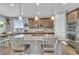 Open kitchen with granite countertops, stainless steel appliances, and a center island with bar seating at 23913 E Swallow Cir, Aurora, CO 80016