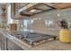 Close-up of a modern cooktop in a well-appointed kitchen with stylish backsplash at 23913 E Swallow Cir, Aurora, CO 80016