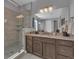 Elegant bathroom with a walk-in shower, updated fixtures, and neutral tile at 23913 E Swallow Cir, Aurora, CO 80016
