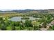 Breathtaking aerial view of a serene community lake nestled amid lush greenery and rolling hills at 8532 W Eden Dr, Littleton, CO 80127