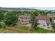 Aerial view of a home with a spacious backyard, large deck, and mountain views, showcasing an ideal outdoor living space at 8532 W Eden Dr, Littleton, CO 80127