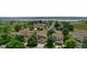 Aerial view of a residential neighborhood with a lake in the background, featuring well-maintained homes with lush landscaping at 8532 W Eden Dr, Littleton, CO 80127