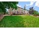 Expansive backyard featuring a large deck and lush green lawn, perfect for outdoor enjoyment at 8532 W Eden Dr, Littleton, CO 80127