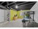 Finished basement with a bunk bed, beanbag and a playful lime green accent wall at 8532 W Eden Dr, Littleton, CO 80127