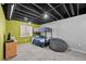 Finished basement with a bunk bed, beanbag and a playful lime green accent wall at 8532 W Eden Dr, Littleton, CO 80127