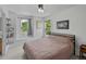 Bright bedroom with large windows, featuring cozy decor and ample natural light at 8532 W Eden Dr, Littleton, CO 80127