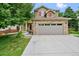 Charming two-story home showcasing a two-car garage, brick accents, and a well-manicured lawn at 8532 W Eden Dr, Littleton, CO 80127