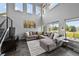 Spacious living room with high ceilings, large windows, slate tile floors, and a comfortable sectional sofa at 8532 W Eden Dr, Littleton, CO 80127