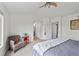 Comfortable bedroom featuring a cozy sitting area, neutral tones, and ample natural light at 8532 W Eden Dr, Littleton, CO 80127