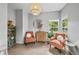 Cozy sitting area featuring stylish chairs, modern lighting, and a curated display cabinet, creating a welcoming atmosphere at 8532 W Eden Dr, Littleton, CO 80127
