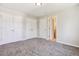 Spacious bedroom with neutral carpet, multiple closets, and ample natural light at 2340 Geneva, Aurora, CO 80010
