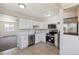 Well-lit kitchen with stainless steel appliances, white cabinetry, and an open layout at 2340 Geneva, Aurora, CO 80010