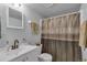 This bathroom features a classic design with a white vanity and a shower with a decorative curtain at 1611 Garfield Ave # 2, Louisville, CO 80027