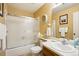 Bright bathroom featuring a shower/tub combo with sliding glass doors and a single sink vanity at 7780 W 87Th Dr # E, Arvada, CO 80005