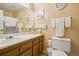 Bathroom featuring a single sink vanity, a large mirror, and decorative shelving at 7780 W 87Th Dr # E, Arvada, CO 80005
