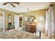 Bedroom features a vanity, mirror, and access to the kitchen area at 7780 W 87Th Dr # E, Arvada, CO 80005