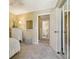 Bedroom featuring mirrored closet doors and an ensuite bathroom at 7780 W 87Th Dr # E, Arvada, CO 80005