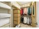 Walk-in closet featuring ample shelving and hanging space for clothes and storage at 7780 W 87Th Dr # E, Arvada, CO 80005
