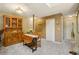 Dining area with natural light showcasing a wooden table, hutch, and access to storage at 7780 W 87Th Dr # E, Arvada, CO 80005
