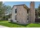 Well-maintained townhome featuring stone accents, neutral siding, and a manicured lawn at 7780 W 87Th Dr # E, Arvada, CO 80005