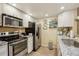 Updated kitchen featuring stainless steel appliances, granite countertops and ample cabinet space at 7780 W 87Th Dr # E, Arvada, CO 80005