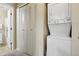 Convenient laundry area with a stacked washer and dryer unit and a utility closet at 7780 W 87Th Dr # E, Arvada, CO 80005