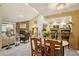 Open-concept living and dining area with a stone fireplace, and a view of the kitchen at 7780 W 87Th Dr # E, Arvada, CO 80005