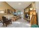 Inviting living room features a stone fireplace, plush carpeting, and sliding doors to a balcony at 7780 W 87Th Dr # E, Arvada, CO 80005