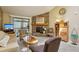 Bright living room with a stone fireplace, carpet, and a balcony offers a cozy space at 7780 W 87Th Dr # E, Arvada, CO 80005