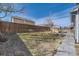 Lawn of backyard with perimeter wooden fence and an outdoor fire pit at 10037 Idalia St, Commerce City, CO 80022
